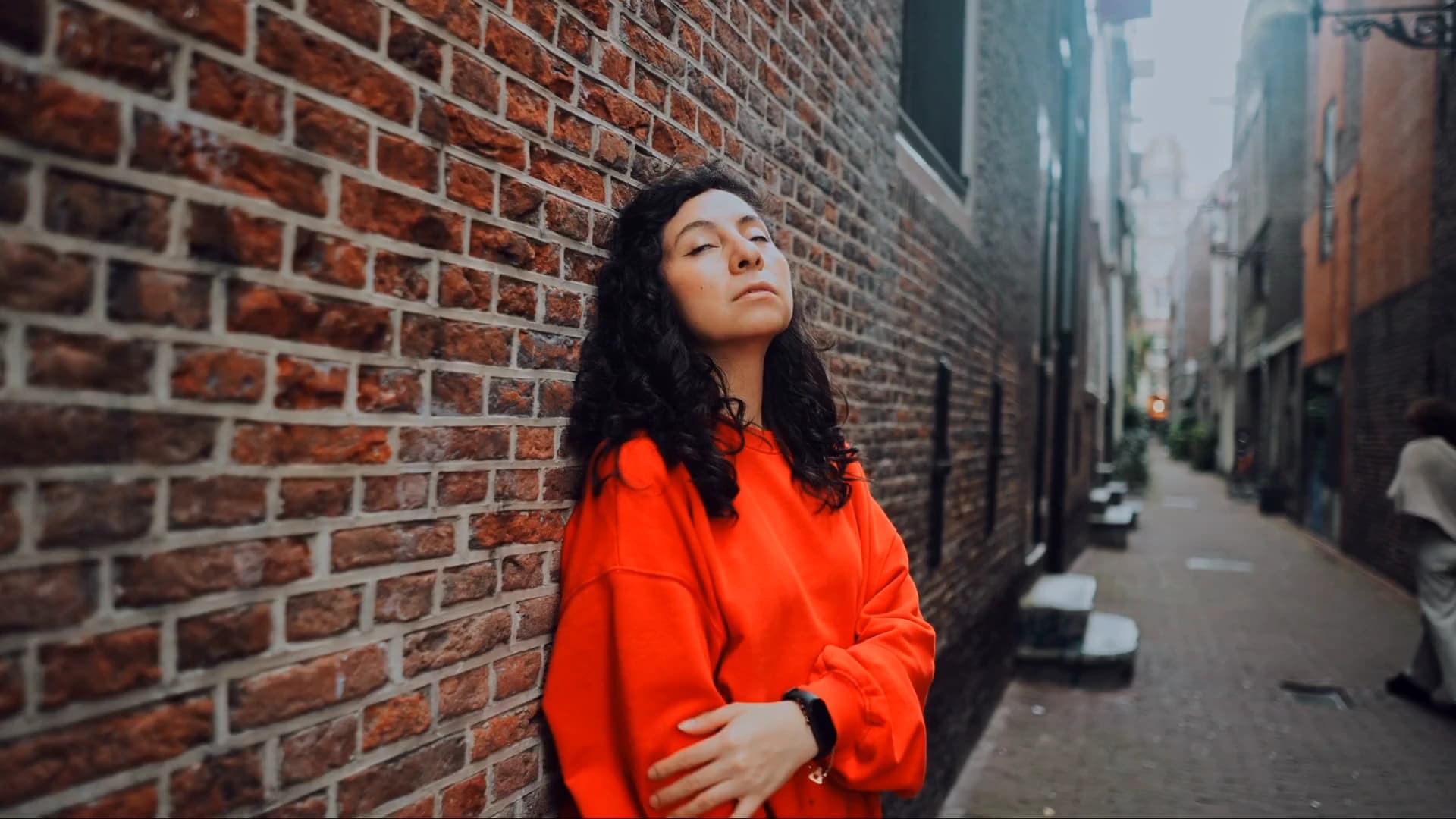 Smart Grade reads the shot of a woman in red in a brick alley, offers grades around the original, then one is picked and its strength is set